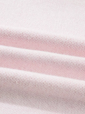 Blush pink knit sweater with a textured fabric detail.