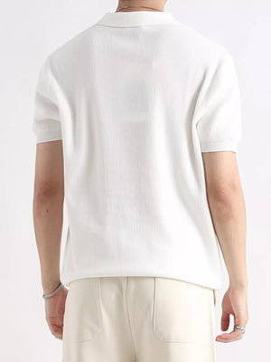 Men's white ribbed short sleeve polo shirt with classic collar.