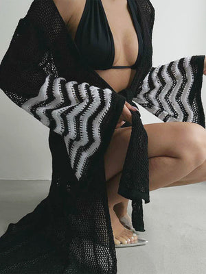 Black knit duster with chevron pattern on bell sleeves, open front, and crochet detail.
