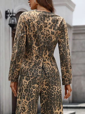 Sleek leopard print denim bolero jacket with collarless neckline and button-up front.