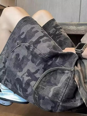 Relaxed fit black camo cargo shorts with large side pockets.