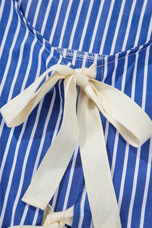 Blue and white striped blouse with a tie-front detail and cream ribbon bow.