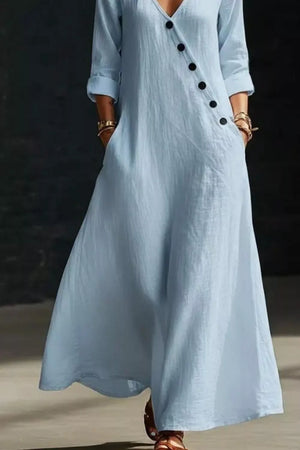 Light blue maxi dress with V-neck, buttoned detail and pockets.
