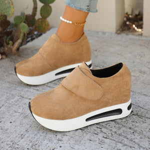 Chunky platform sneakers in brown suede with air cushion soles and hook-and-loop closure.