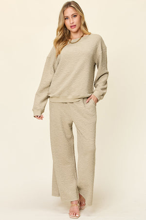 Textured loungewear set in tan with crewneck sweatshirt and wide-leg pants.