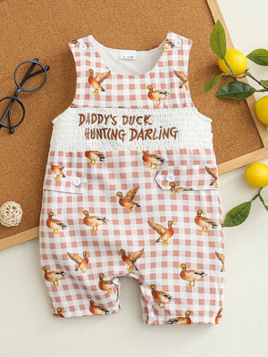 Baby one-piece with duck print on pink gingham, smocked waist, and button details.