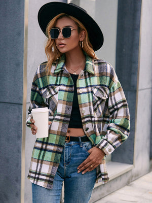 Oversized green plaid flannel shacket with patch pockets and buttoned front.