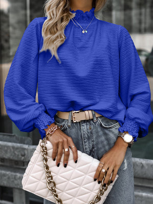 Royal blue textured puff sleeve blouse with smocked neck and cuffs.
