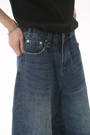 Wide-leg denim culottes in light blue with a relaxed fit and distressed details.