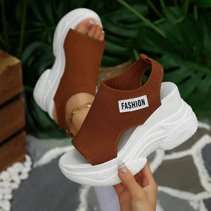 Brown open-toe wedge sandals with white chunky sole and "FASHION" label.