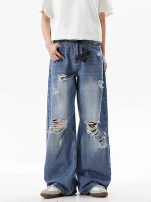 Men's distressed wide-leg jeans in blue denim with ripped details and a relaxed fit.