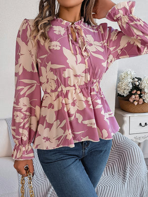 Floral peplum blouse with ruffled neck and tie detail in pink purple, long sleeves, cinched waist
