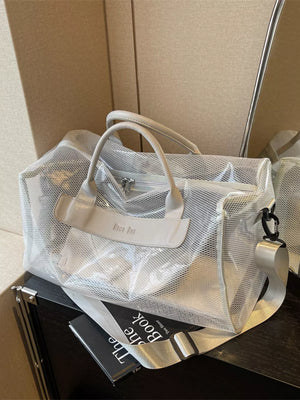 Light gray mesh travel organizer bag with clear PVC panels and leather accents.