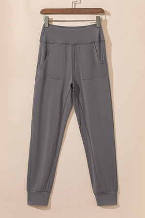 Dark gray joggers with performance fit, elastic waistband, and two front pockets.