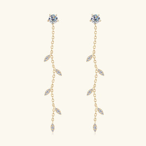Gold dangling crystal vine earrings with delicate leaf-shaped accents.