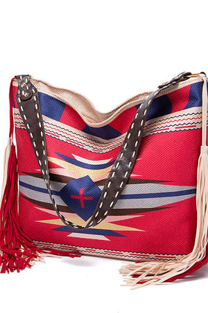 Southwestern hobo bag with multicolor geometric pattern, canvas material, and fringe details.