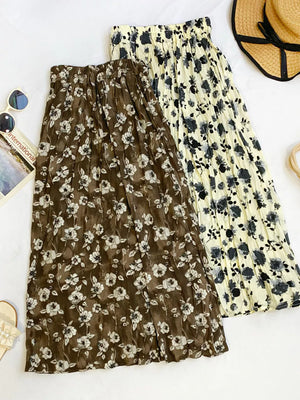 Botanical print midi skirts in black and tan with crinkled fabric and elastic waistbands.