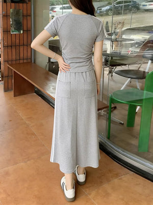 Gray striped tee and midi skirt ensemble with side stripe detail.