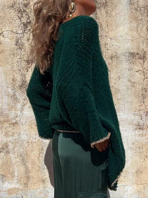 Dark green open knit sweater with asymmetric hem and beaded trim detail.