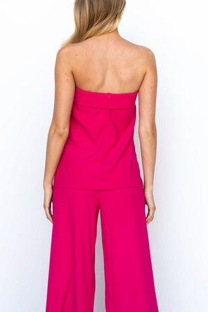 Hot pink structured bandeau top and wide-leg pants suit from the back.