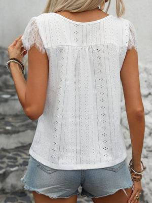 White eyelet blouse with lace trim short sleeves and button-down front detail.