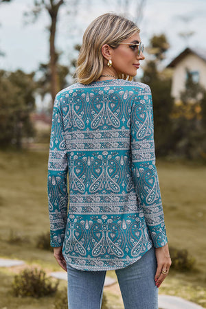 Turquoise paisley print long sleeve blouse with gathered detail.