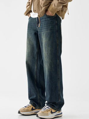 Loose fit blue cotton denim jeans with vintage wash and visible distressing.