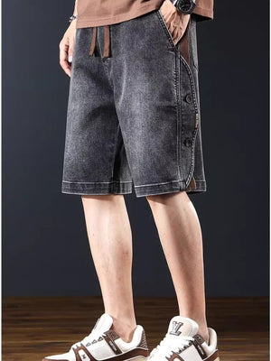 Men's dark gray wide leg denim shorts with button detail and drawstring waist