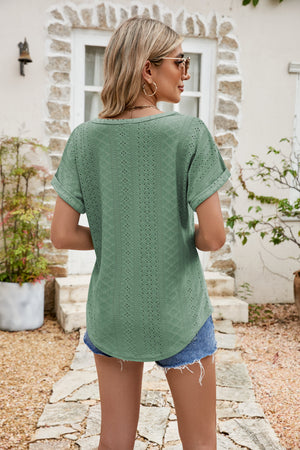 Green perforated tee with rolled cuff short sleeves and a scoop neck.