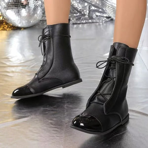 Black two-tone cap-toe lace-up ankle boots with patent toe detail.
