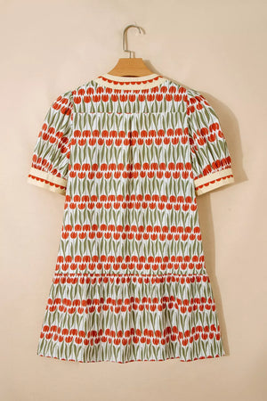 Cotton mini dress with red tulip print, short sleeves, and tiered skirt.