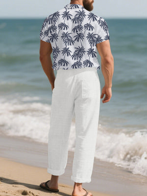 Men's white relaxed fit pants with a back pocket, cuffed hem, and textured fabric.