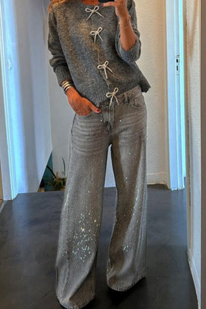 Gray knit sweater with white lace-up detail and tie bows, long sleeves, crew neck