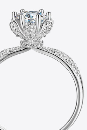 Silver halo ring with a floral-inspired moissanite center stone and diamond accents.