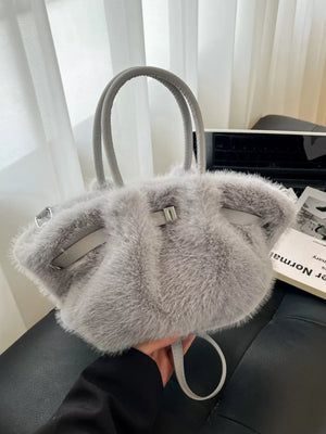 Plush gray crossbody bag with chic buckle and leather trim.