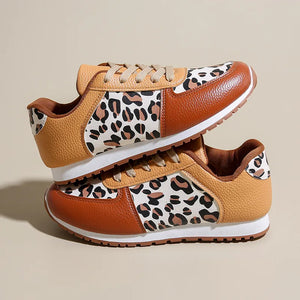 Leopard print panel sneakers in caramel and brown leather with white soles.