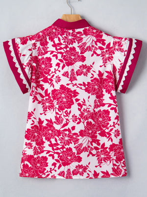 White polyester blouse with a bold pink floral print, lace trim on sleeves, and a stand collar.