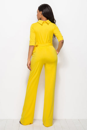 Yellow belted palazzo jumpsuit with high neckline and 3/4 sleeves.