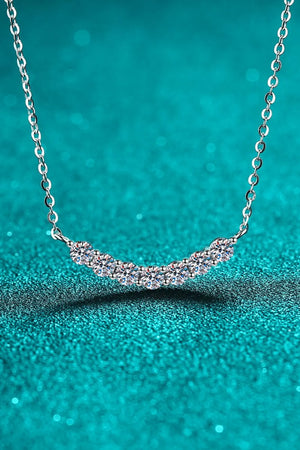 Silver moissanite necklace with a curved row of seven sparkling stones on a delicate chain.