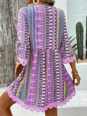 Bohemian printed light purple v-neck dress with bell sleeves and lace trim.