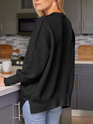 Black ribbed-knit relaxed fit sweater with a collar detail and side slits.