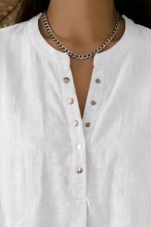 White sleeveless maternity shirt with snap-down placket and band collar.