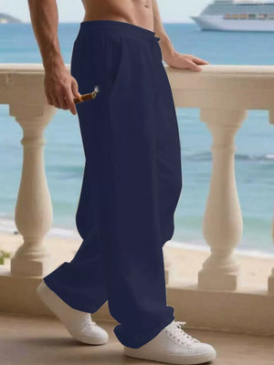 Navy blue linen joggers for men with drawstring waist and pockets, styled with white sneakers.