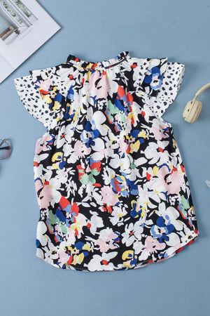 Dalmatian Trim Floral Print Blouse with ruffled neckline and flutter sleeves.