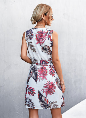 White floral mini dress with tie waist and zip front, sleeveless.