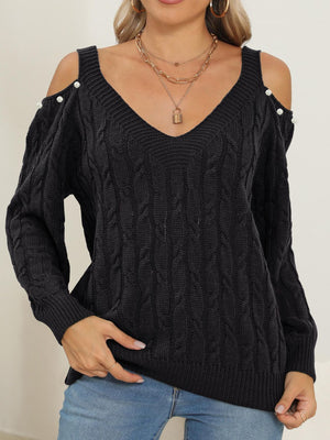 Black cable knit sweater with cold-shoulder detail and pearl buttons, V-neck