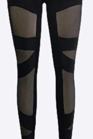Black leggings with geometric mesh panels on the legs.