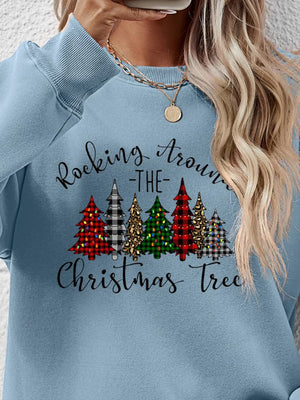 Misty Blue crewneck sweatshirt with a graphic of Christmas trees and text that reads Rocking Around the Christmas Tree.