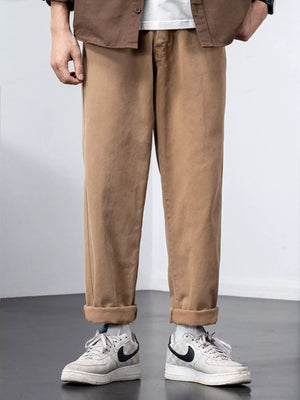 Plus-size khaki cotton wide-leg trousers with cuffed hems.