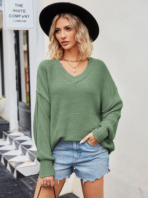 Oversized slouch knit v-neck sweater in green, featuring a relaxed fit and casual style.